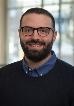 three quarter portrait of Nathan in dress shirt and sweater